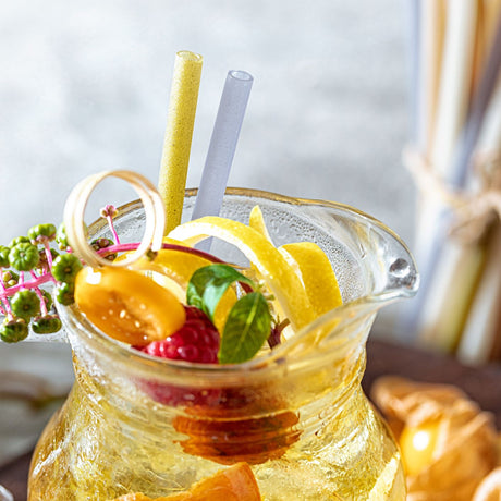 rice straws in a large pitcher of juice