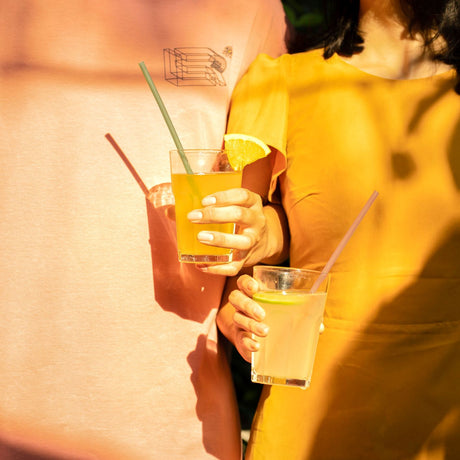 a couple sharing drinks with rice straws as their straw of choice